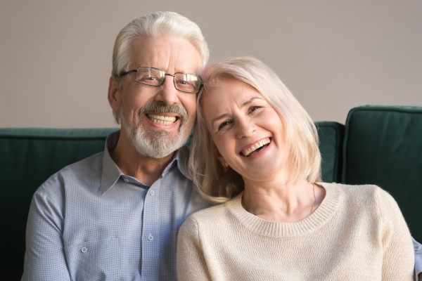 older couple leaning on each other and smiling